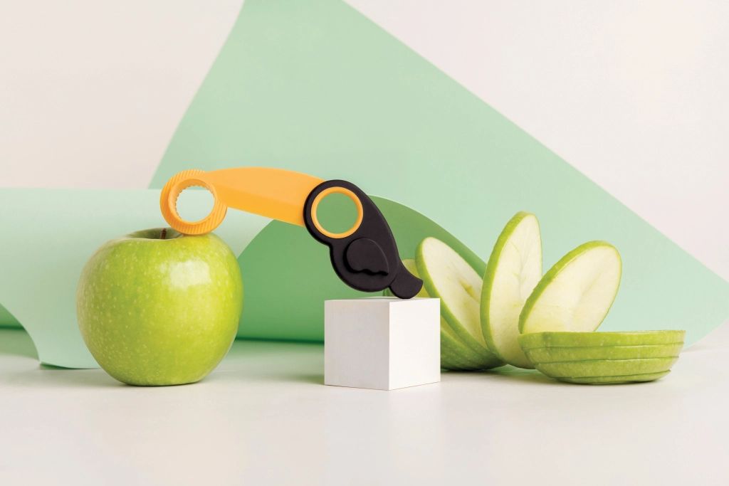 A playful apple peeler, slicer, and corer in the shape of a bird, displayed against a white background.